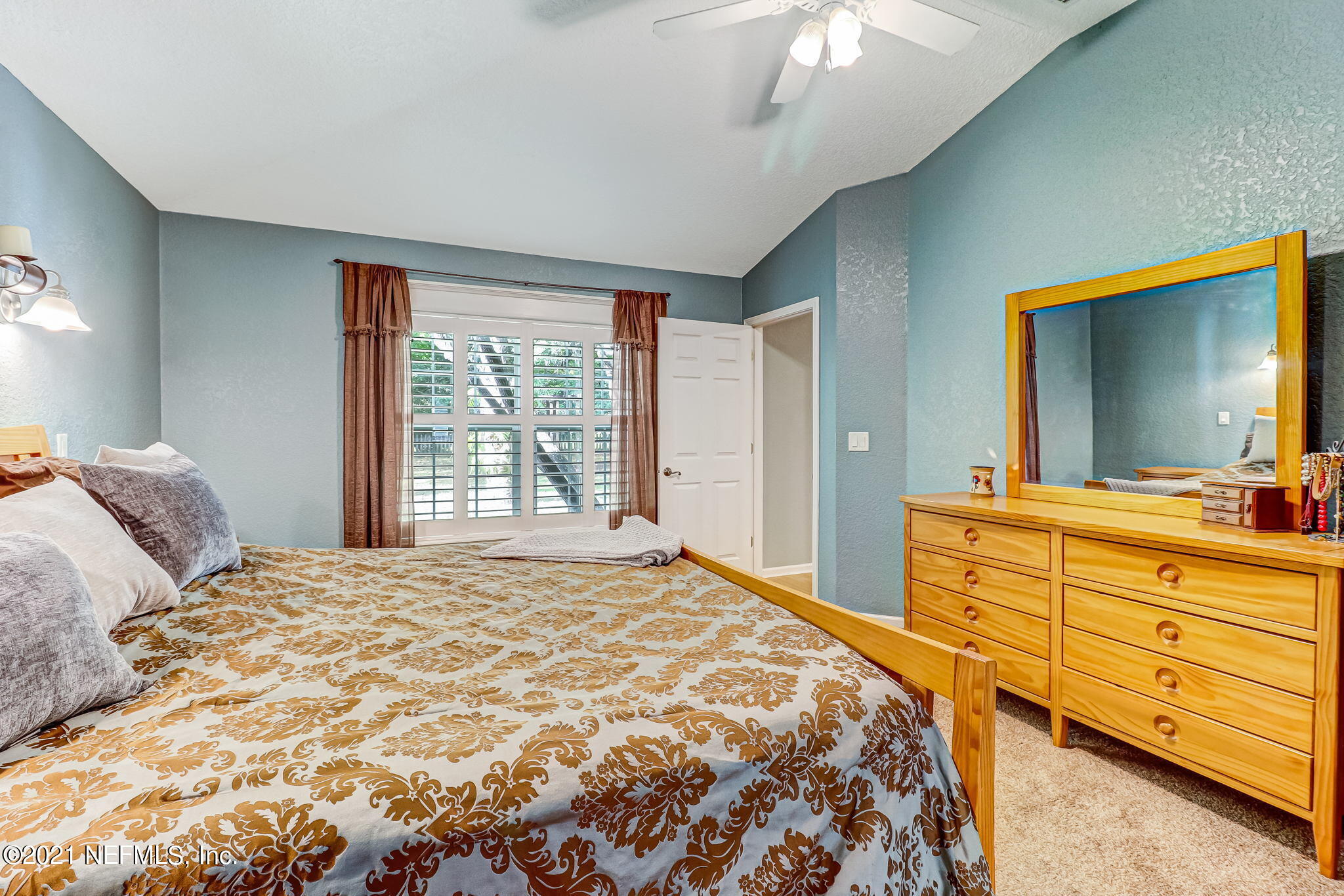 96931 Blackrock Road Yulee, FL 32097 - Photo 15 of 28 a bedroom with a large bed and a dresser