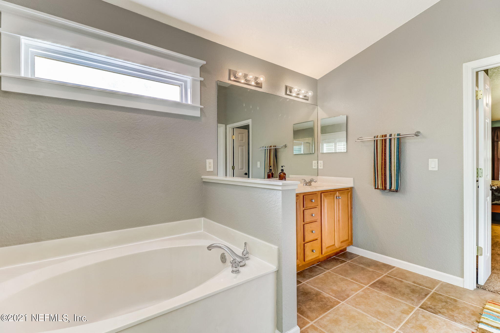 96931 Blackrock Road Yulee, FL 32097 - Photo 17 of 28 a bathroom with a tub sink and mirror