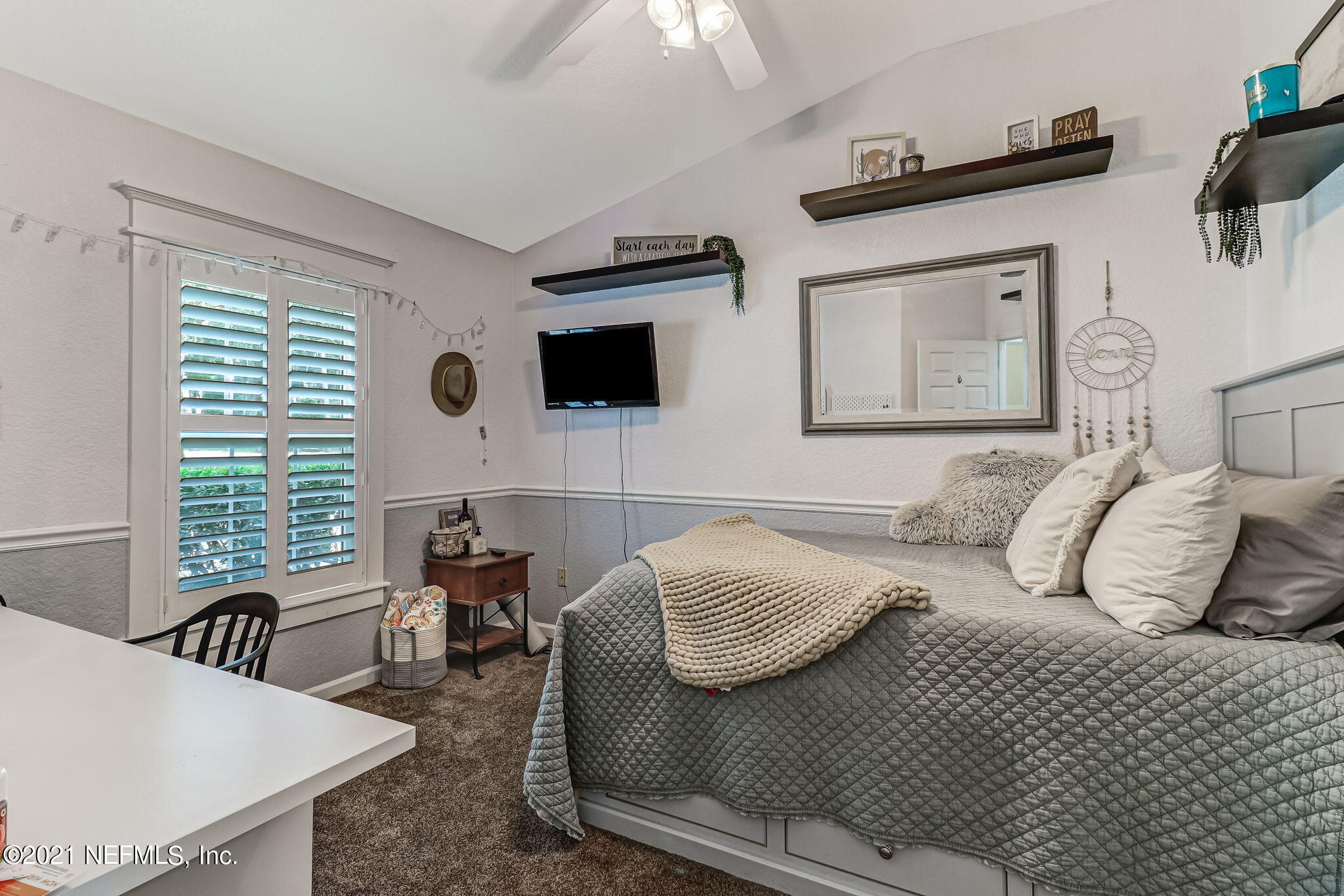 96931 Blackrock Road Yulee, FL 32097 - Photo 19 of 28 a bedroom with a bed and a flat screen tv