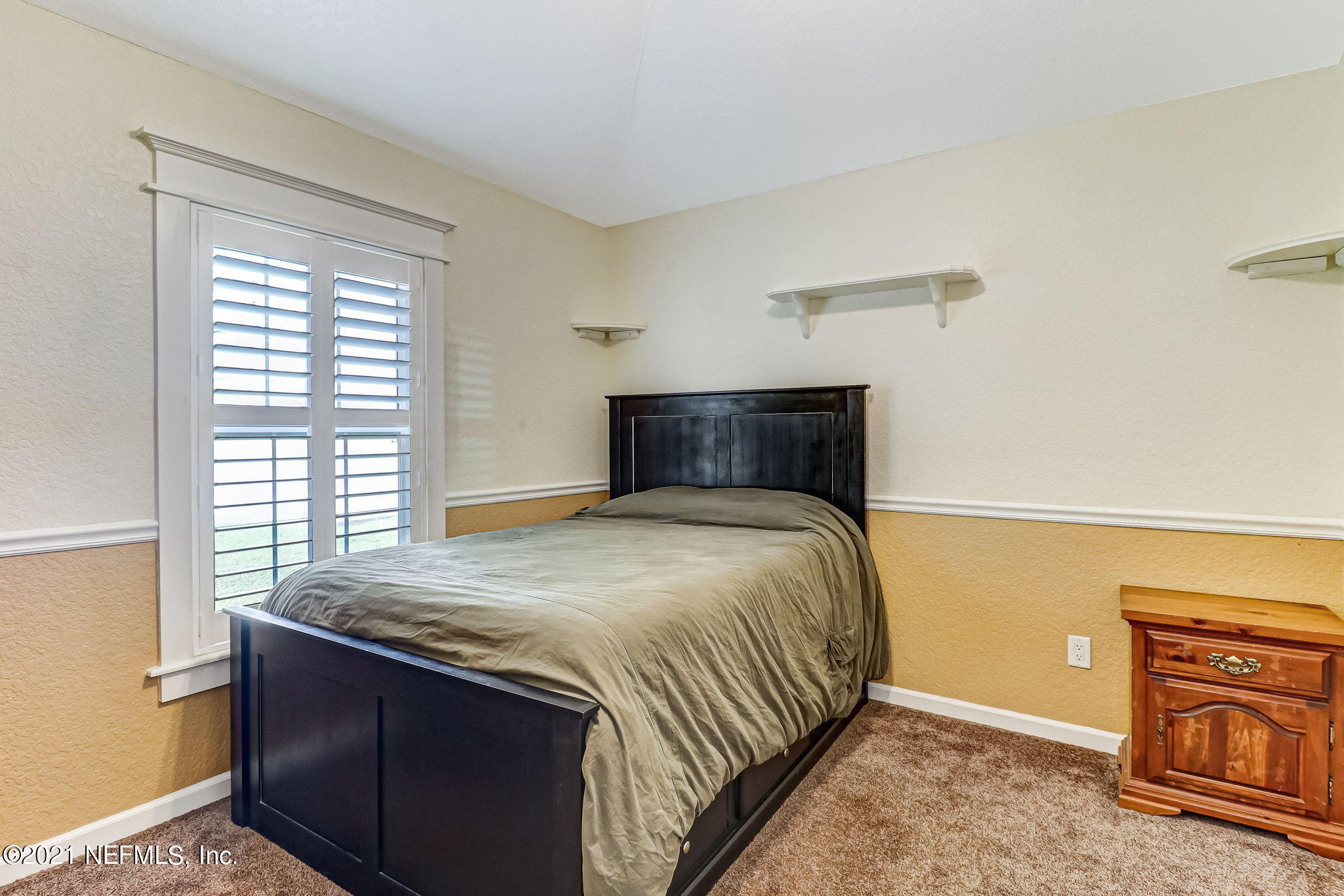 96931 Blackrock Road Yulee, FL 32097 - Photo 21 of 28 a bedroom with a bed and a flat tv screen on dresser