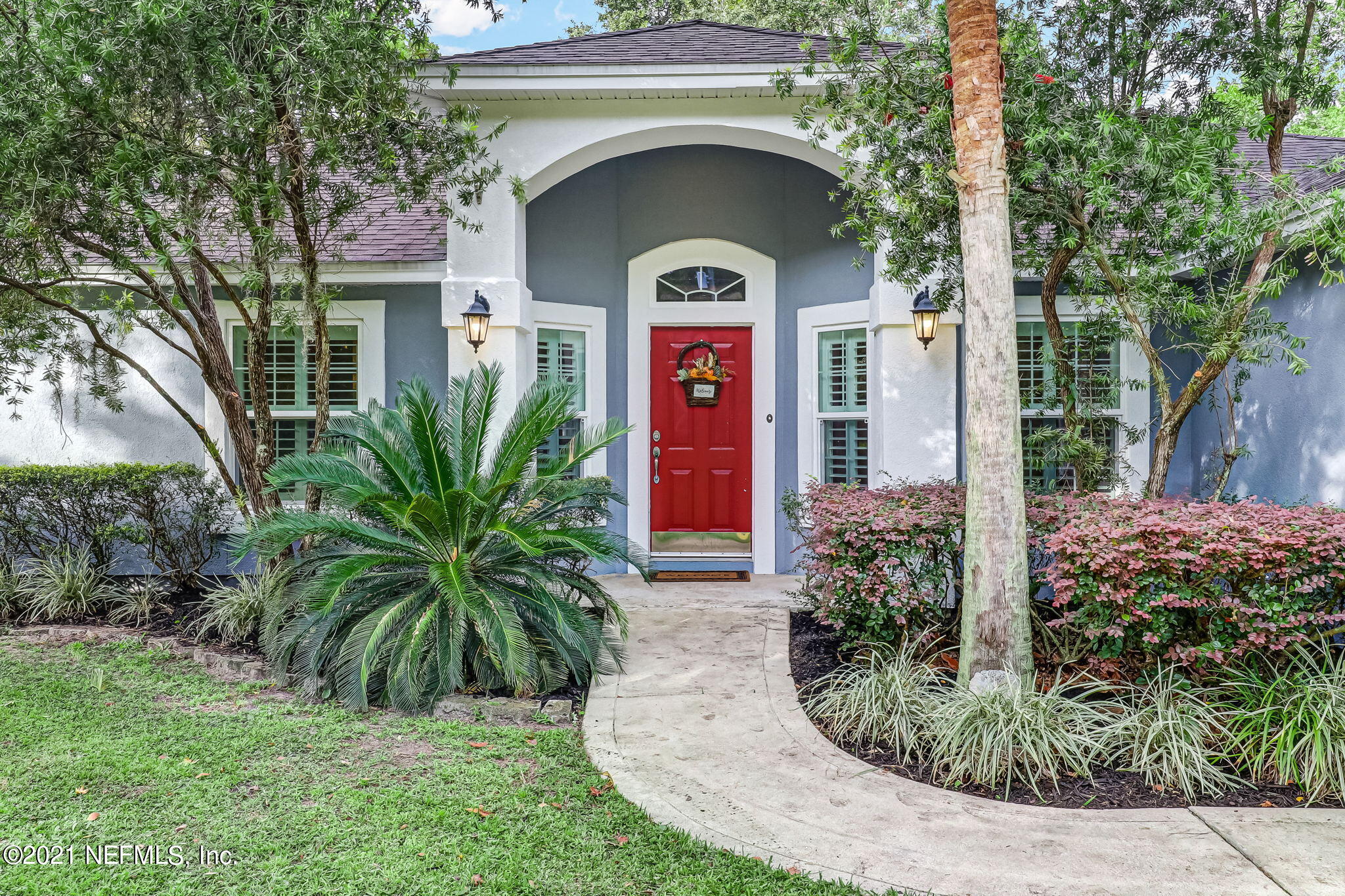 96931 Blackrock Road Yulee, FL 32097 - Photo 3 of 28 a front view of a house with garden