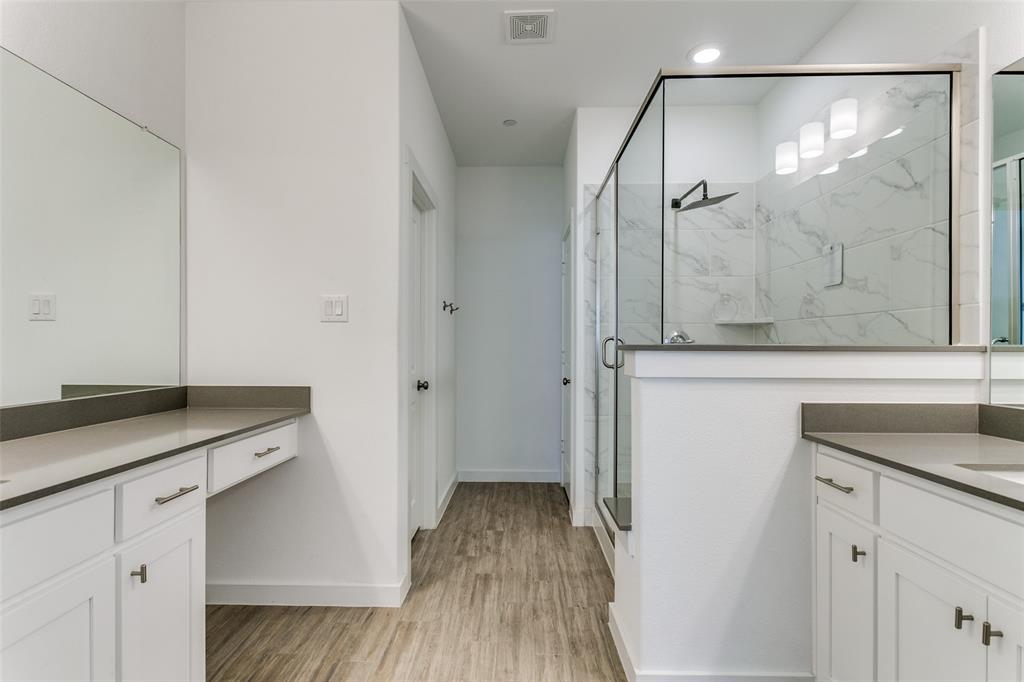 663 Vista Oaks Road Lewisville, TX 75067 - Photo 11 of 12 a bathroom with a granite countertop sink a mirror and shower