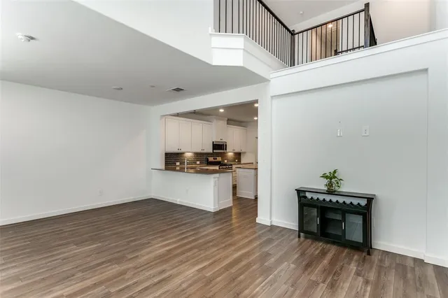 a kitchen view with kitchen island a sink and wooden floor