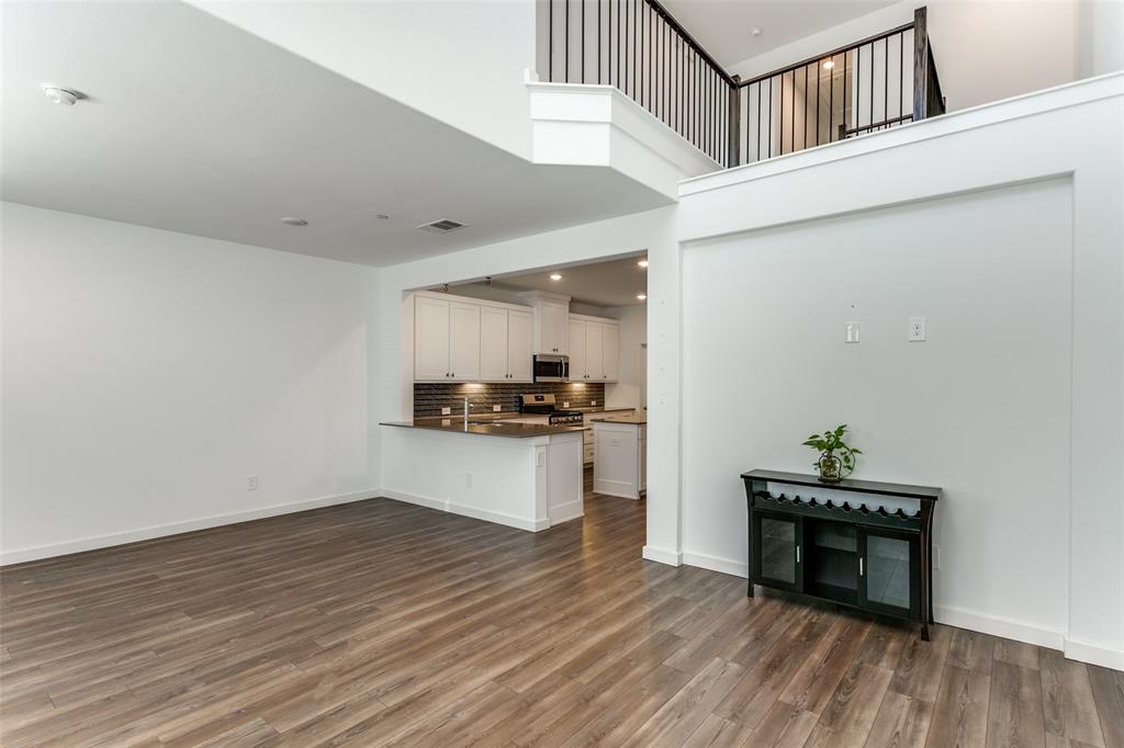 663 Vista Oaks Road Lewisville, TX 75067 - Photo 4 of 12 a kitchen view with kitchen island a sink and wooden floor