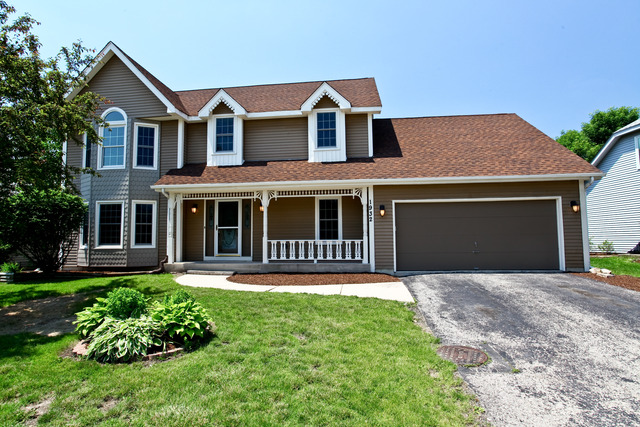 1932 Slippery Rock Road Naperville, IL 60565 - Photo 1 of 14 a front view of a house with a garden and yard