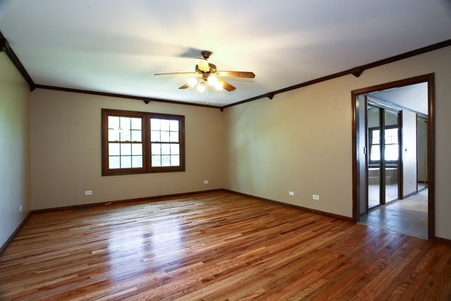 1932 Slippery Rock Road Naperville, IL 60565 - Photo 8 of 14 a view of an empty room with wooden floor and a window