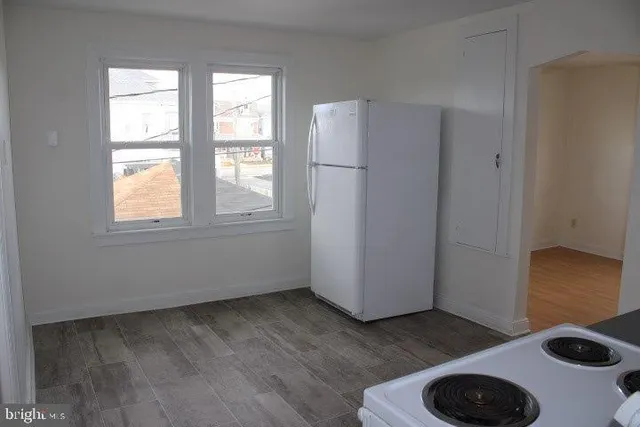 a view of entryway with workspace and wooden floor