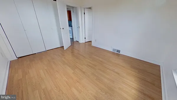 a view of a room with wooden floor