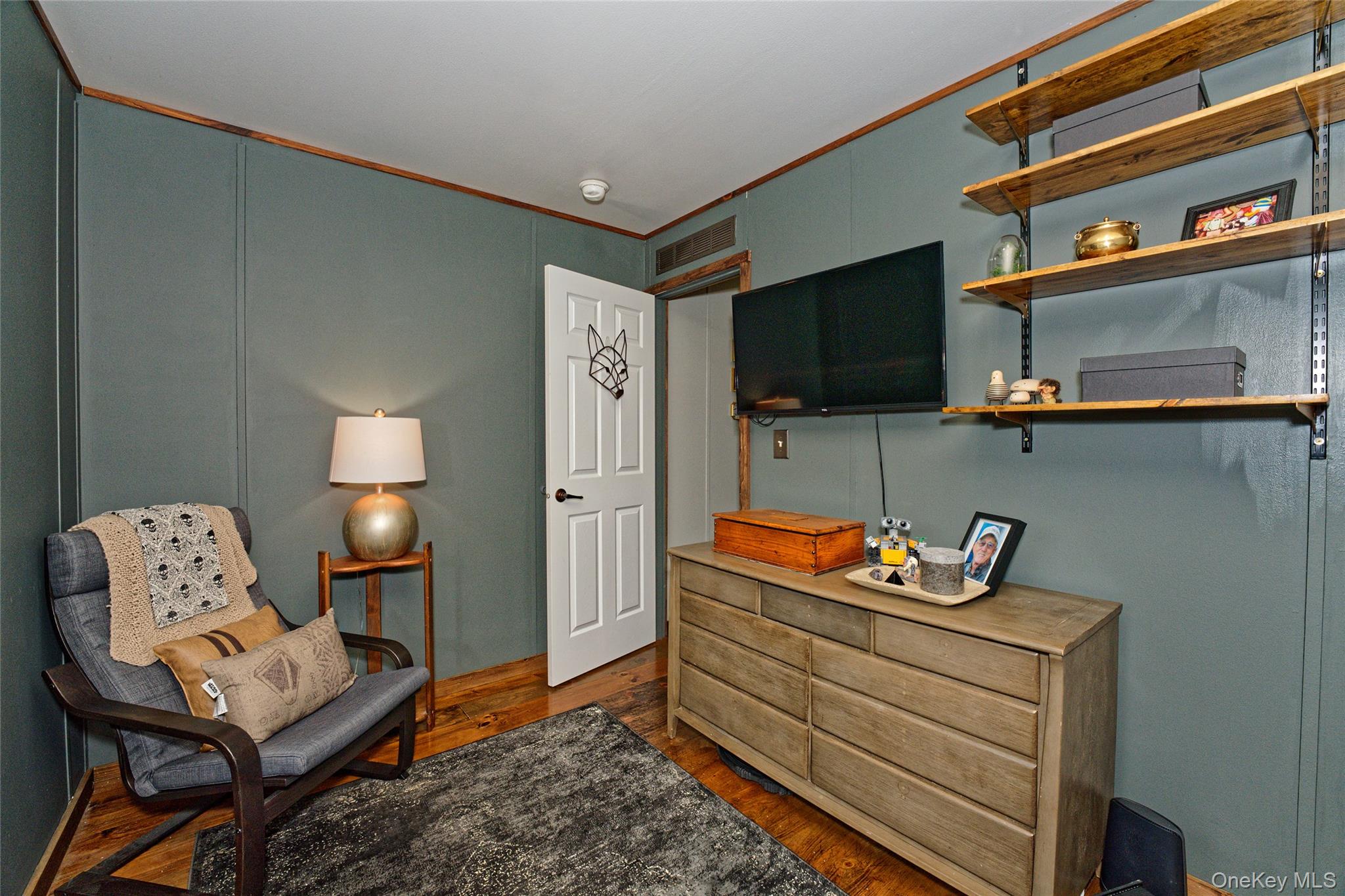 28 Matthew Drive Castleton-on-Hudson, NY 12033 - Photo 13 of 26 Living area with crown molding, dark wood-style floors, and a decorative wall