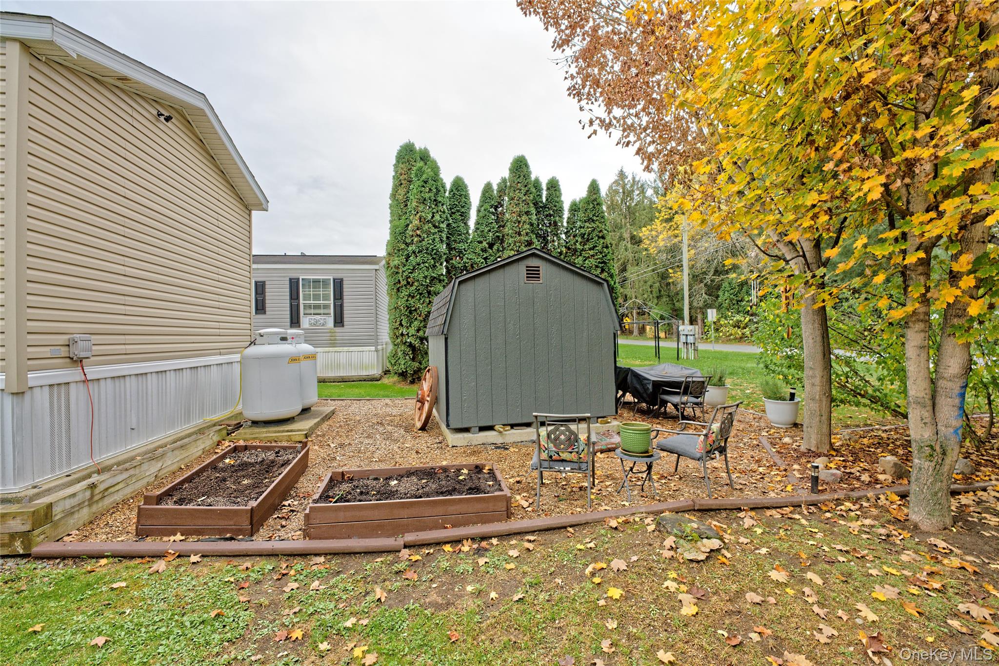 28 Matthew Drive Castleton-on-Hudson, NY 12033 - Photo 23 of 26 View of yard featuring a storage unit, a vegetable garden, and a patio