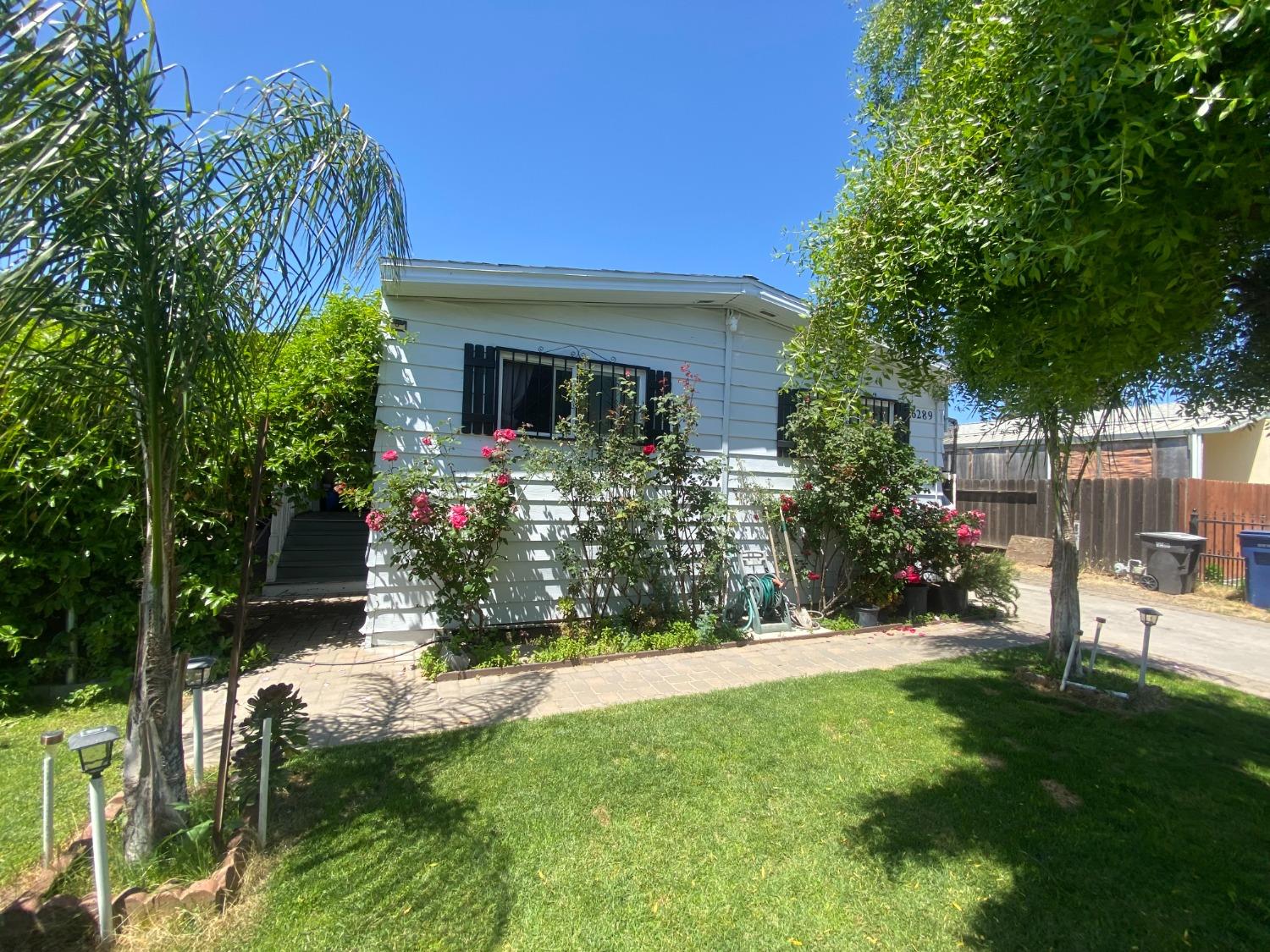 6289 Monica Way Winton, CA 95388 - Photo 17 of 27 a view of house with a yard and sitting area
