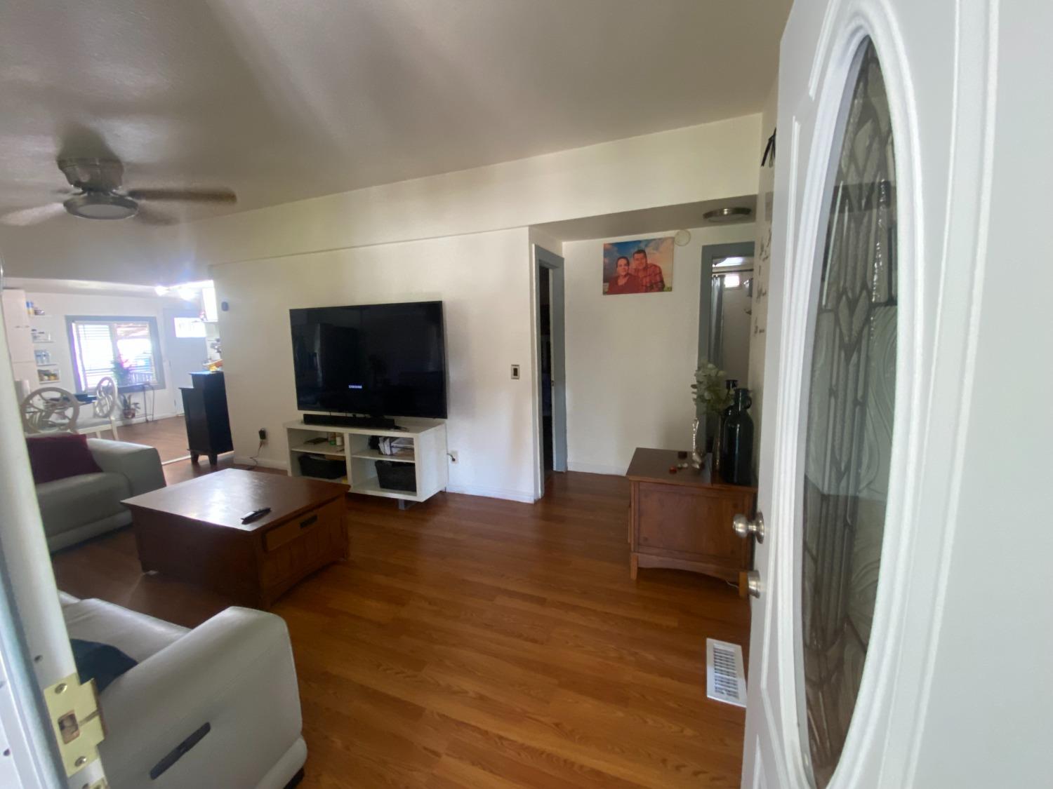 6289 Monica Way Winton, CA 95388 - Photo 4 of 27 a living room with furniture and a flat screen tv