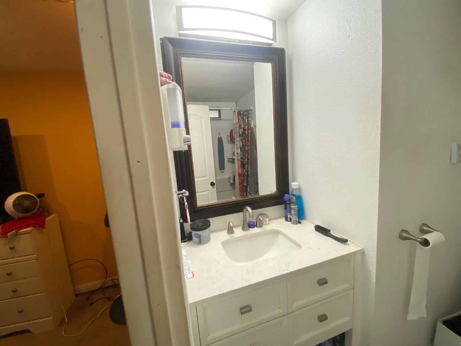 6289 Monica Way Winton, CA 95388 - Photo 6 of 27 a bathroom with a sink and a mirror