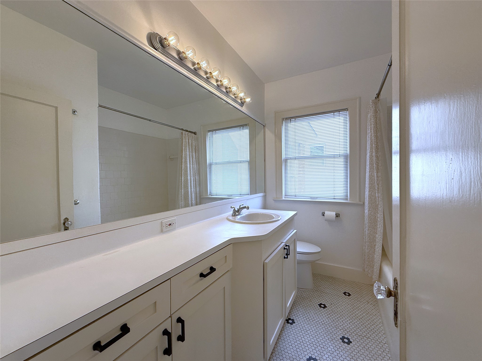 2311 Wroxton Road Houston, TX 77005 - Photo 19 of 24 The bathroom offers and extended vanity with ample storage & tub/shower combo.