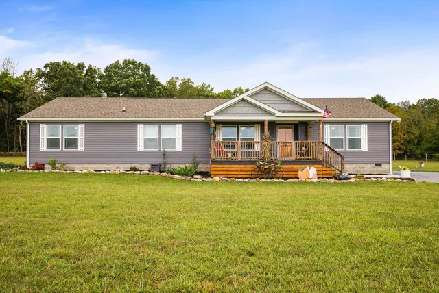 a front view of a house with swimming pool having outdoor seating