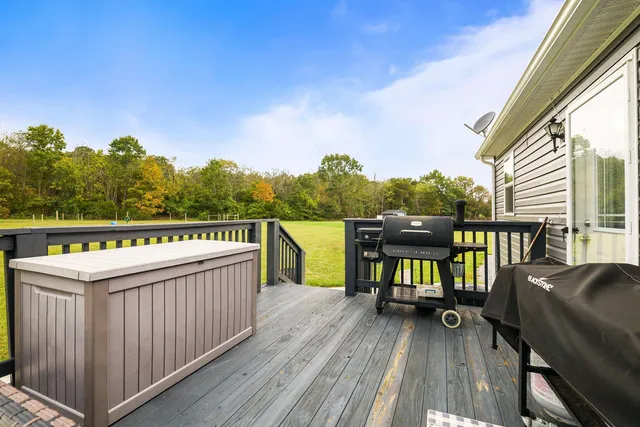 a view of a house with a yard patio and wooden fence