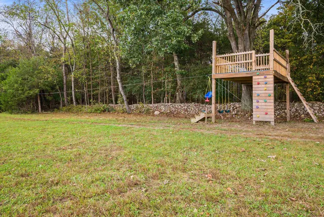 a front view of a house with swimming pool yard and outdoor seating