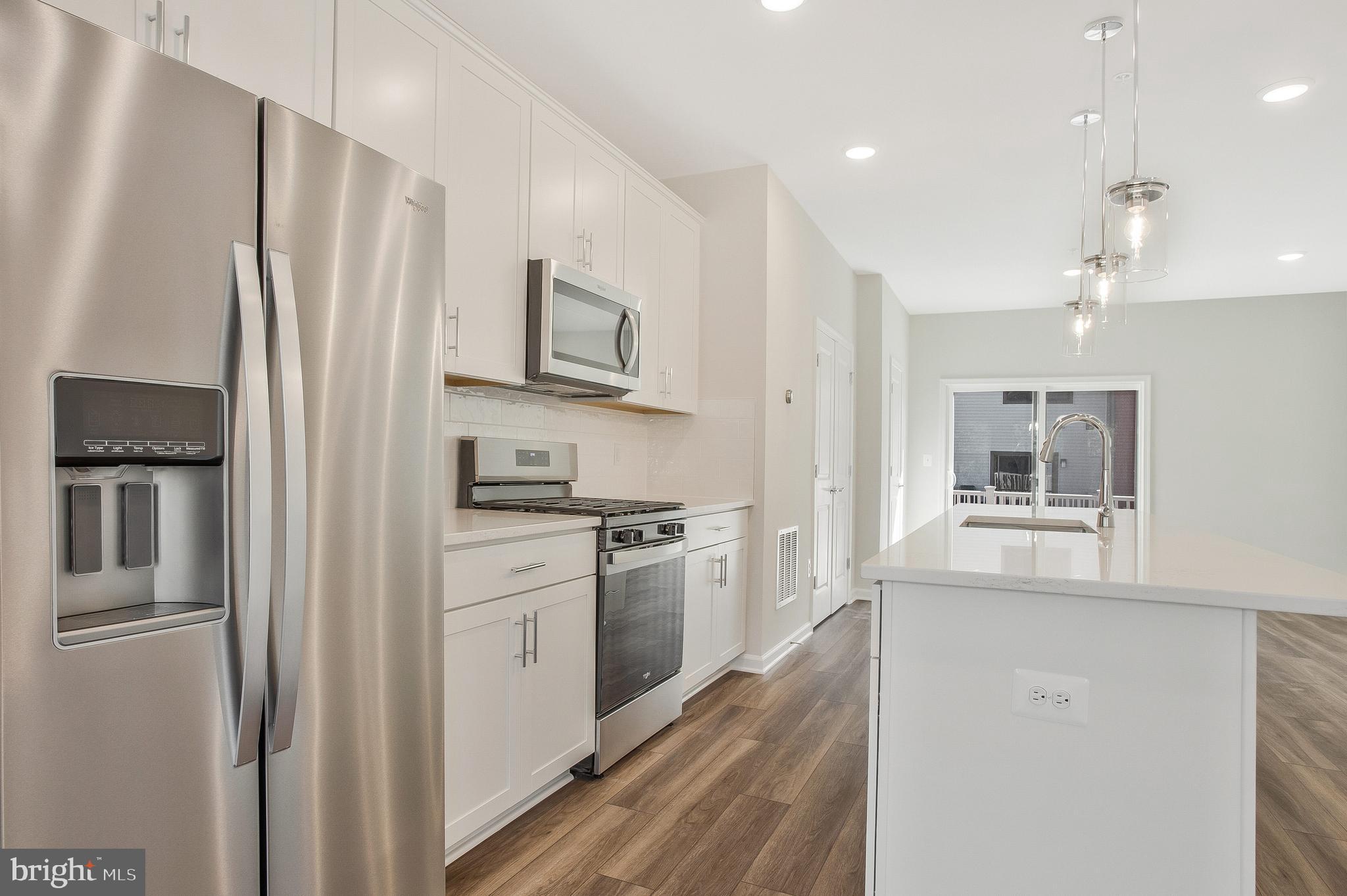 244 Mainstream Drive Laurel, MD 20724 - Photo 12 of 36 a kitchen with stainless steel appliances a refrigerator sink and microwave