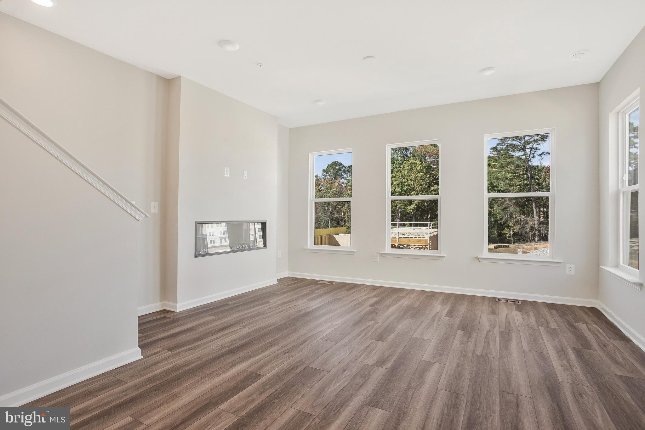244 Mainstream Drive Laurel, MD 20724 - Photo 14 of 36 a view of an empty room with wooden floor and a window