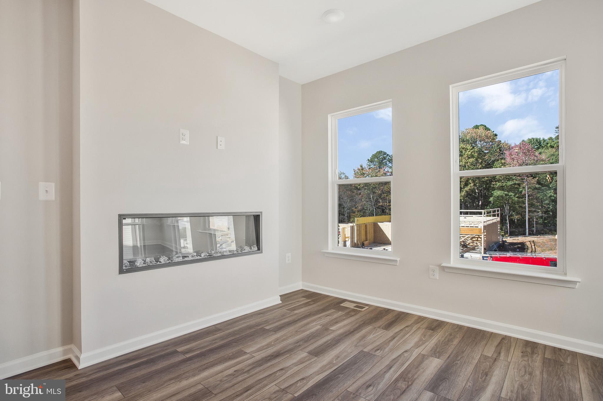 244 Mainstream Drive Laurel, MD 20724 - Photo 15 of 36 a view of an empty room with wooden floor and a window
