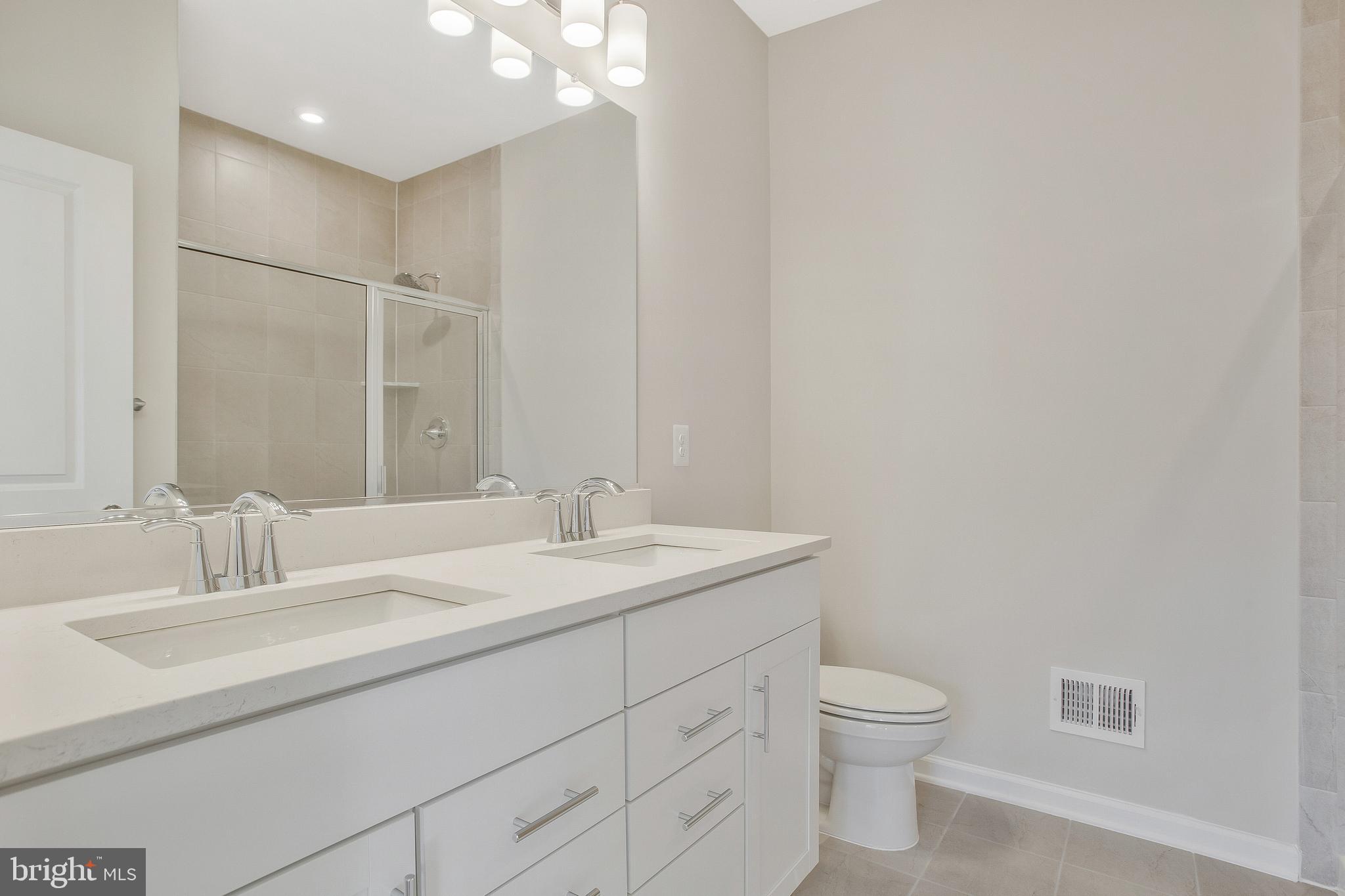 244 Mainstream Drive Laurel, MD 20724 - Photo 20 of 36 a bathroom with a granite countertop sink a toilet and a mirror