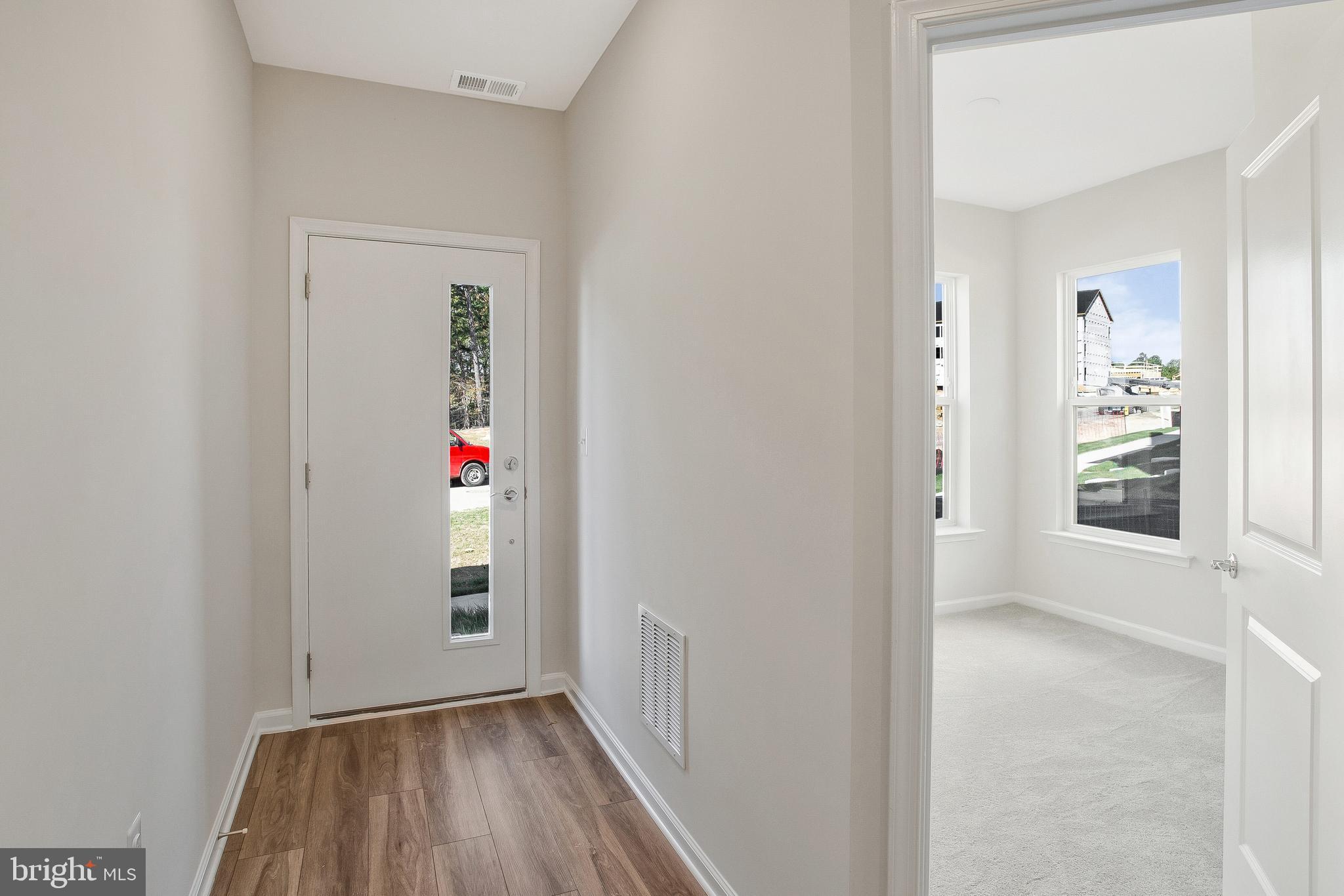 244 Mainstream Drive Laurel, MD 20724 - Photo 2 of 36 an entryway to room with wooden floor and windows