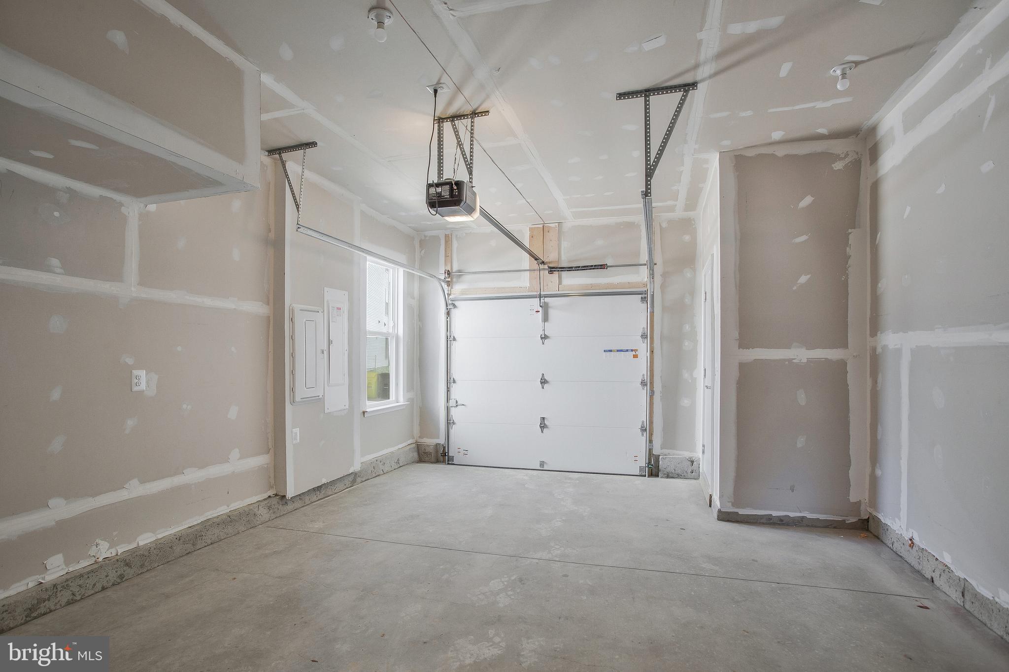 244 Mainstream Drive Laurel, MD 20724 - Photo 26 of 36 an empty room with stairs and wooden door