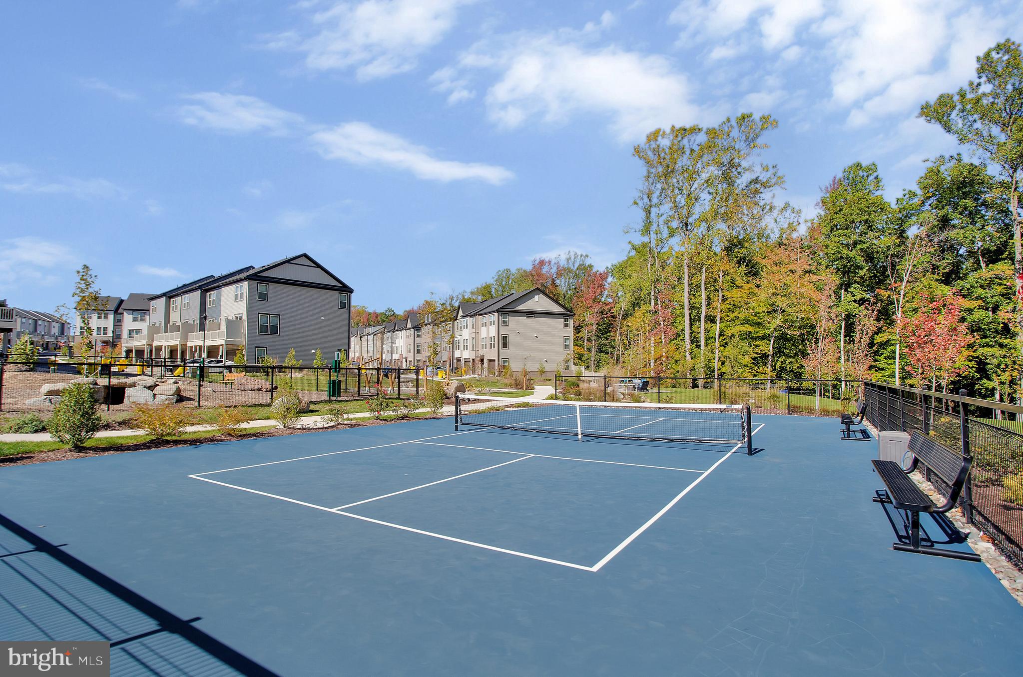 244 Mainstream Drive Laurel, MD 20724 - Photo 28 of 36 a view of a tennis ground with large trees
