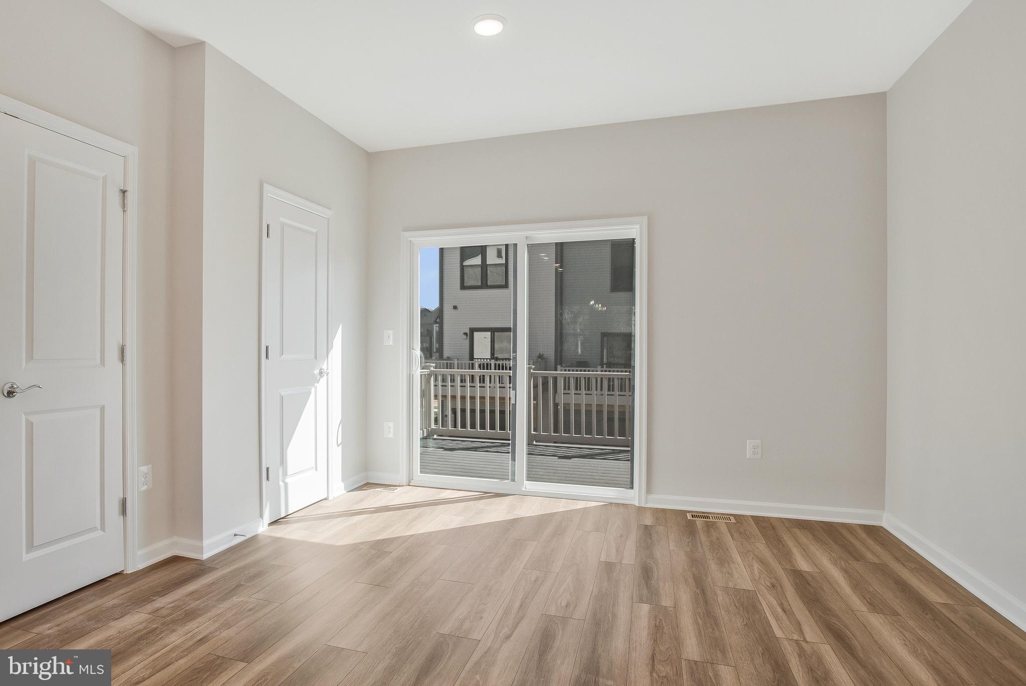 244 Mainstream Drive Laurel, MD 20724 - Photo 4 of 36 an empty room with wooden floor and windows