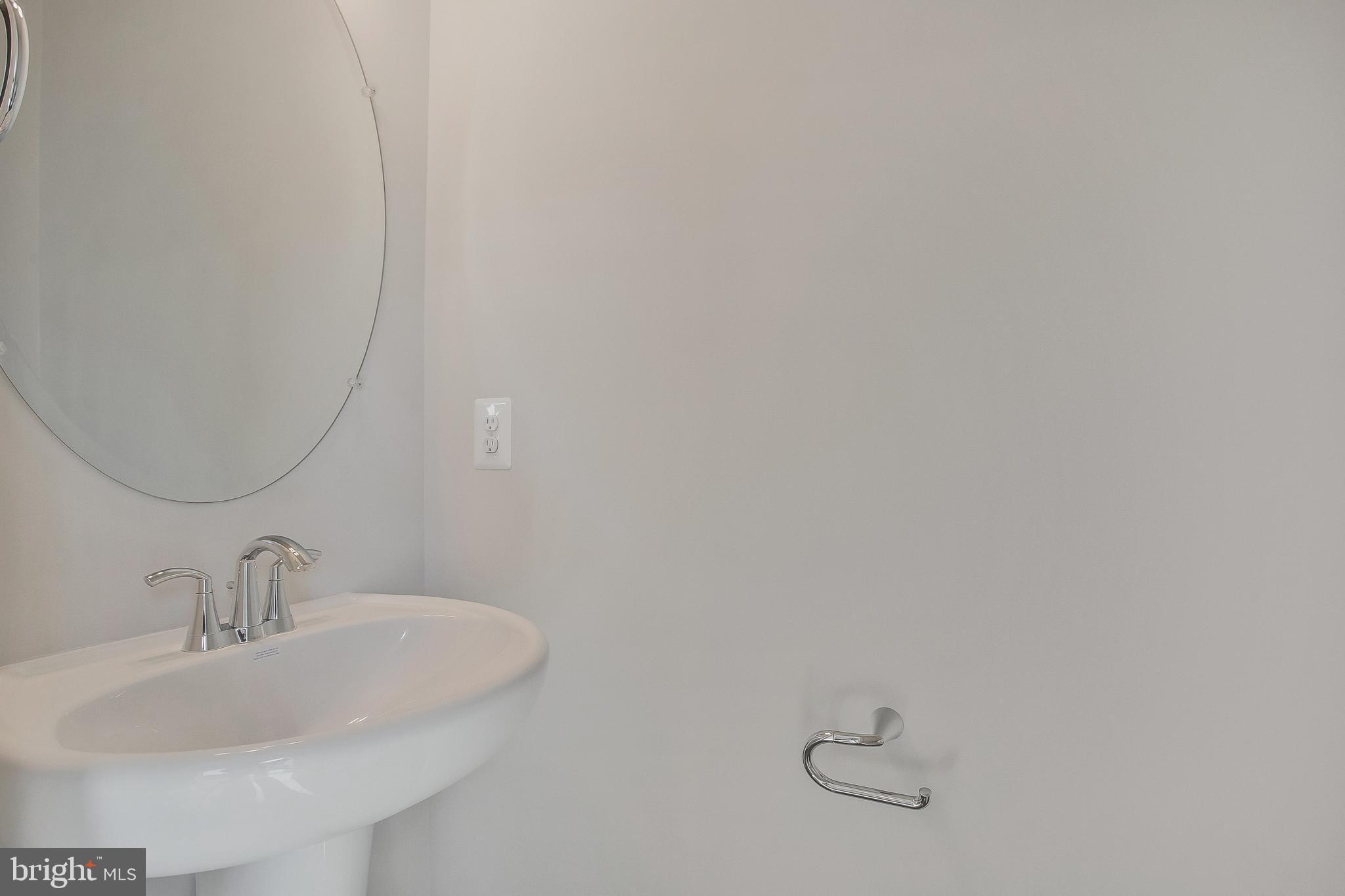 244 Mainstream Drive Laurel, MD 20724 - Photo 5 of 36 a bathroom with a sink and mirror