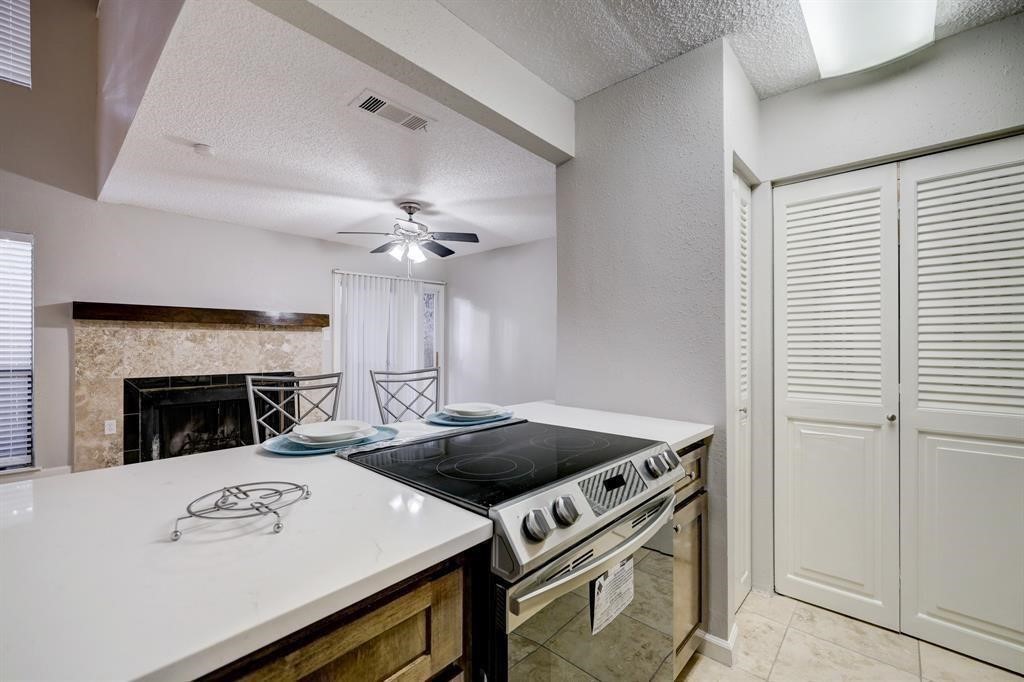3616 Ocee Street Houston, TX 77063 - Photo 5 of 12 a view of a kitchen with workspace and fireplace