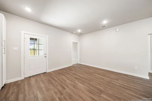 a large kitchen with stainless steel appliances granite countertop a large stove a sink dishwasher and a microwave oven with wooden floor