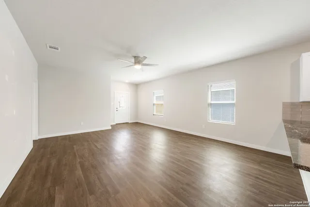 a kitchen with stainless steel appliances granite countertop a sink stove and wooden floor