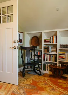 a view of living room with furniture and book shelf