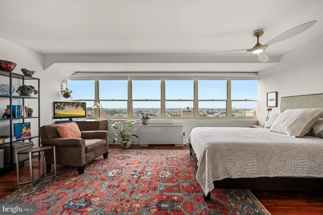 a bedroom with furniture and a large window