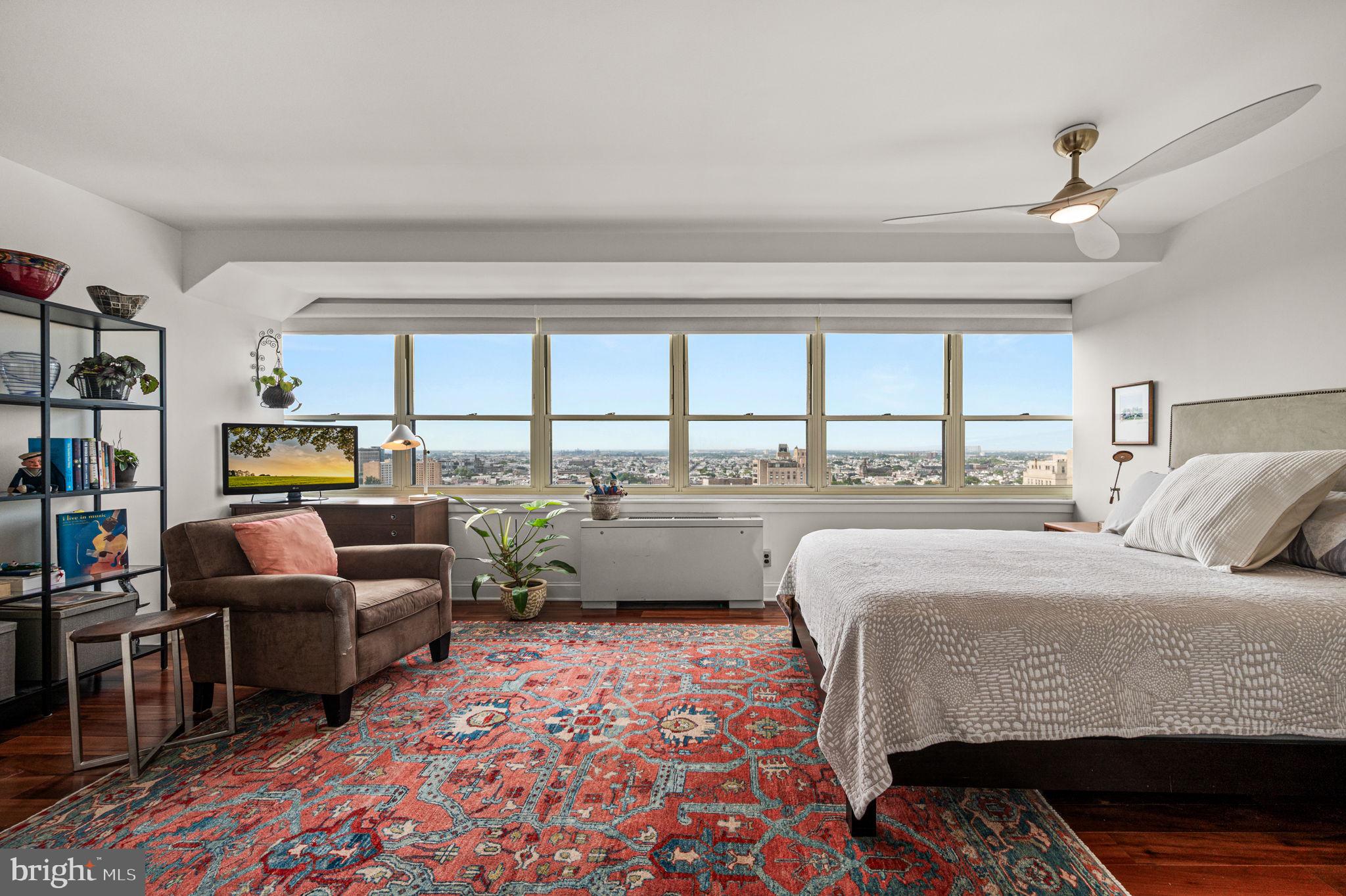 1806-18 Rittenhouse Square, Unit 190607 Philadelphia, PA 19103 - Photo 13 of 34 a bedroom with furniture and a large window