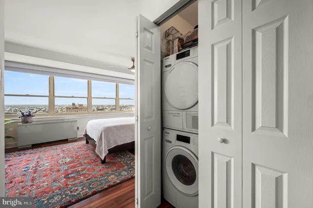 a living room with furniture a rug and a floor to ceiling window