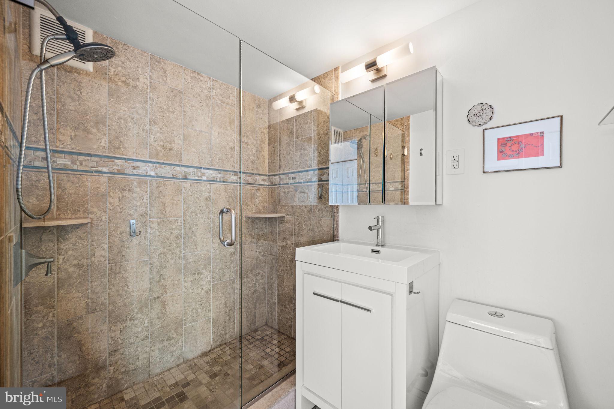 1806-18 Rittenhouse Square, Unit 190607 Philadelphia, PA 19103 - Photo 16 of 34 a bathroom with a sink a toilet and shower