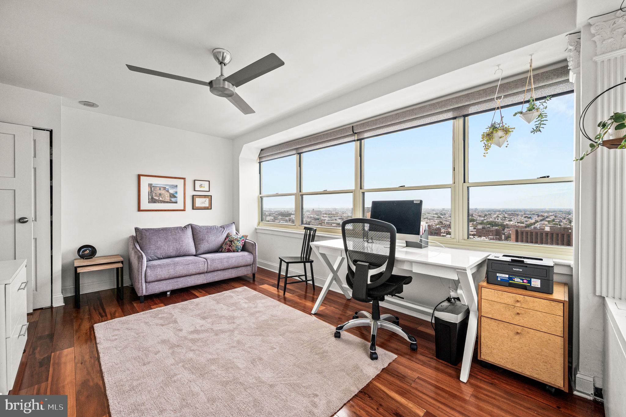 1806-18 Rittenhouse Square, Unit 190607 Philadelphia, PA 19103 - Photo 17 of 34 a living room with furniture a large window and wooden floor