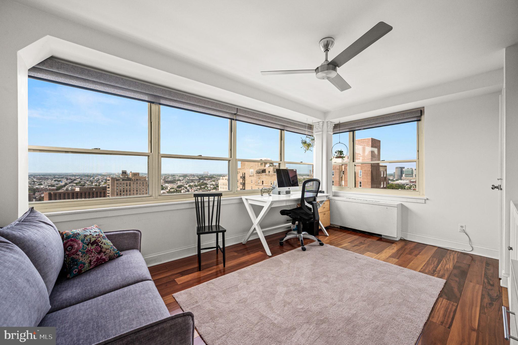 1806-18 Rittenhouse Square, Unit 190607 Philadelphia, PA 19103 - Photo 18 of 34 a living room with furniture a rug and a floor to ceiling window