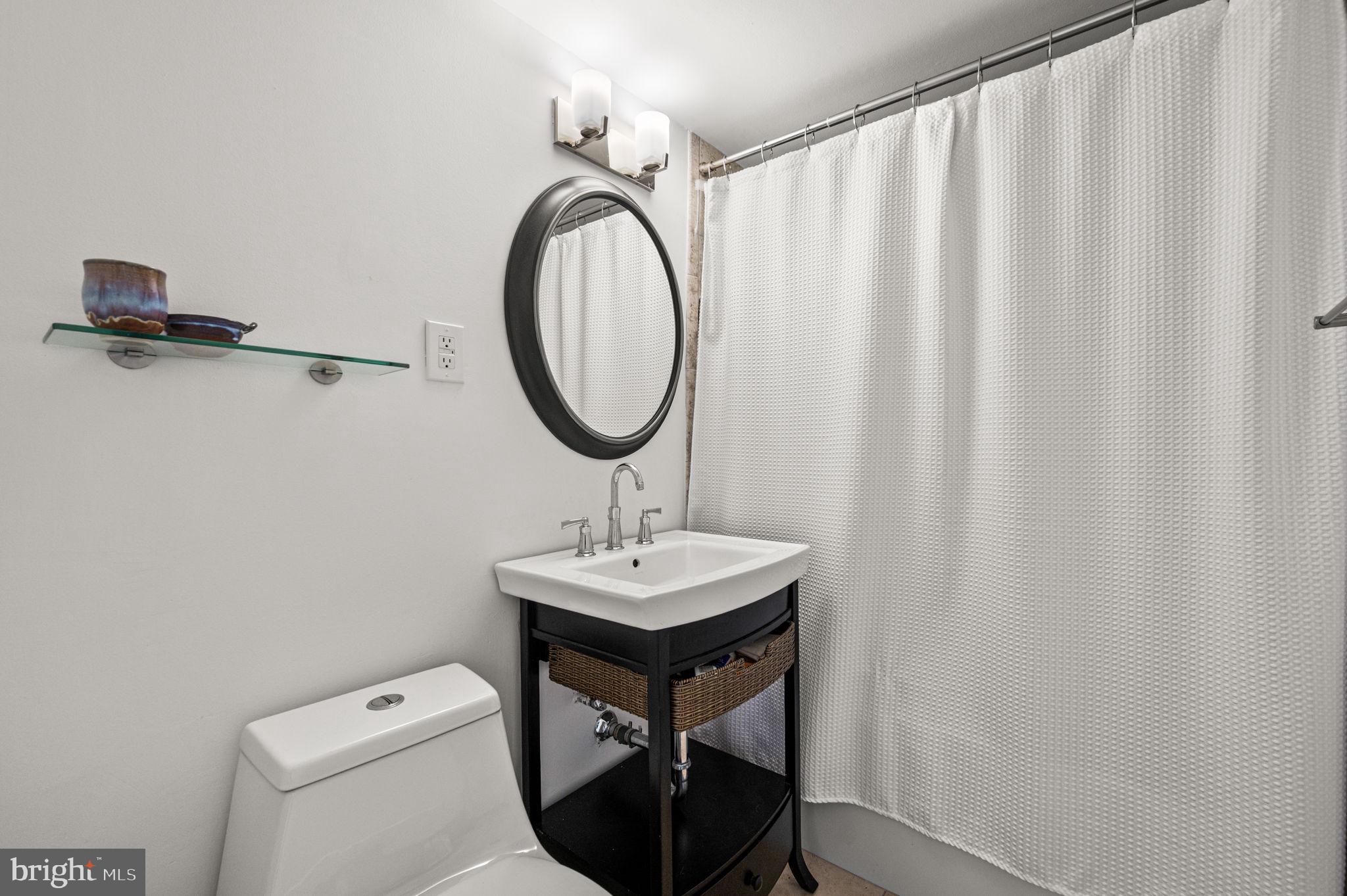 1806-18 Rittenhouse Square, Unit 190607 Philadelphia, PA 19103 - Photo 19 of 34 a bathroom with a toilet a sink and a mirror