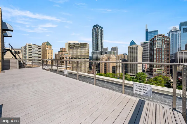 a view of roof deck with tall buildings