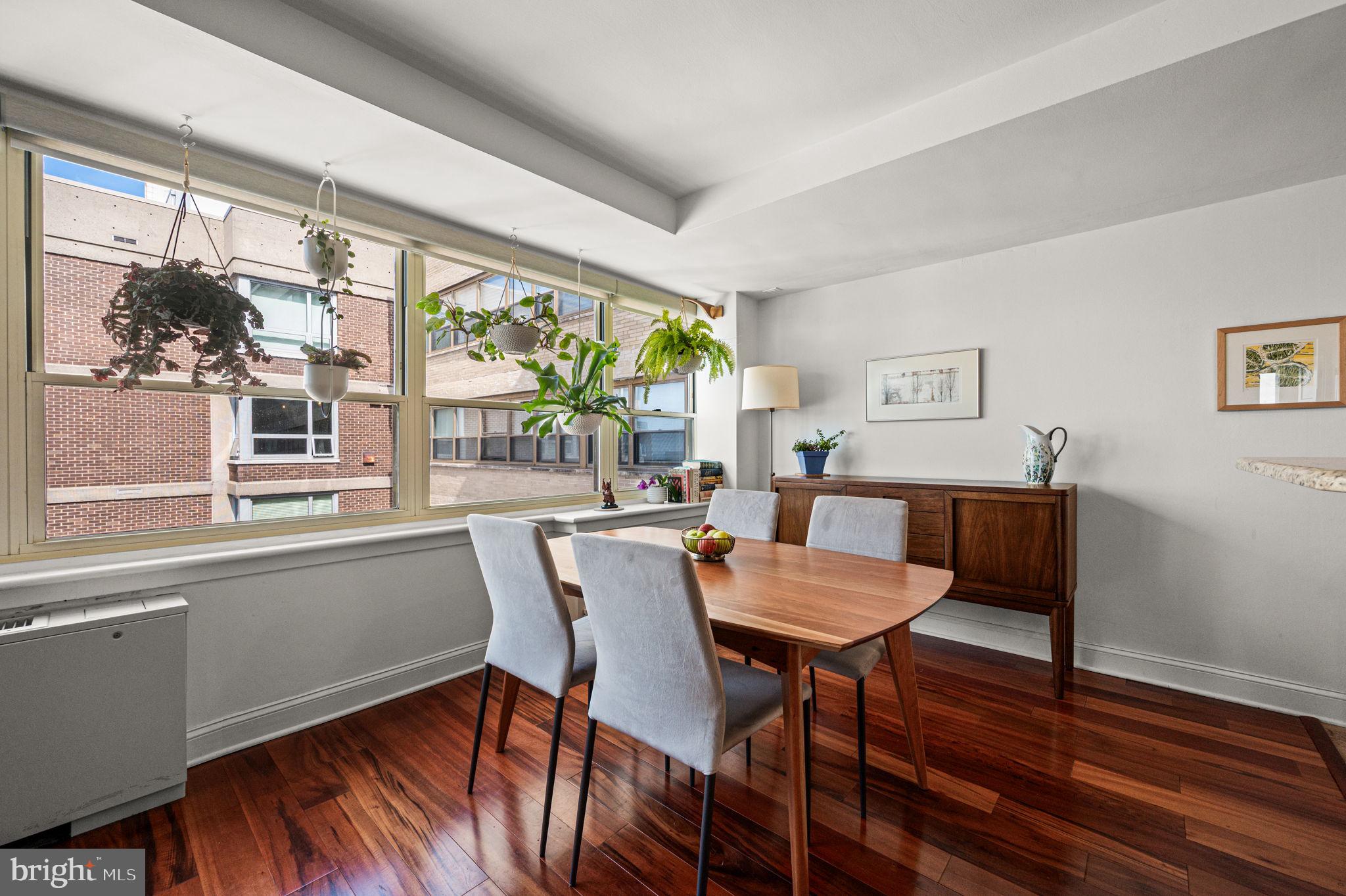 1806-18 Rittenhouse Square, Unit 190607 Philadelphia, PA 19103 - Photo 5 of 34 a view of a dining room with furniture large window and wooden floor