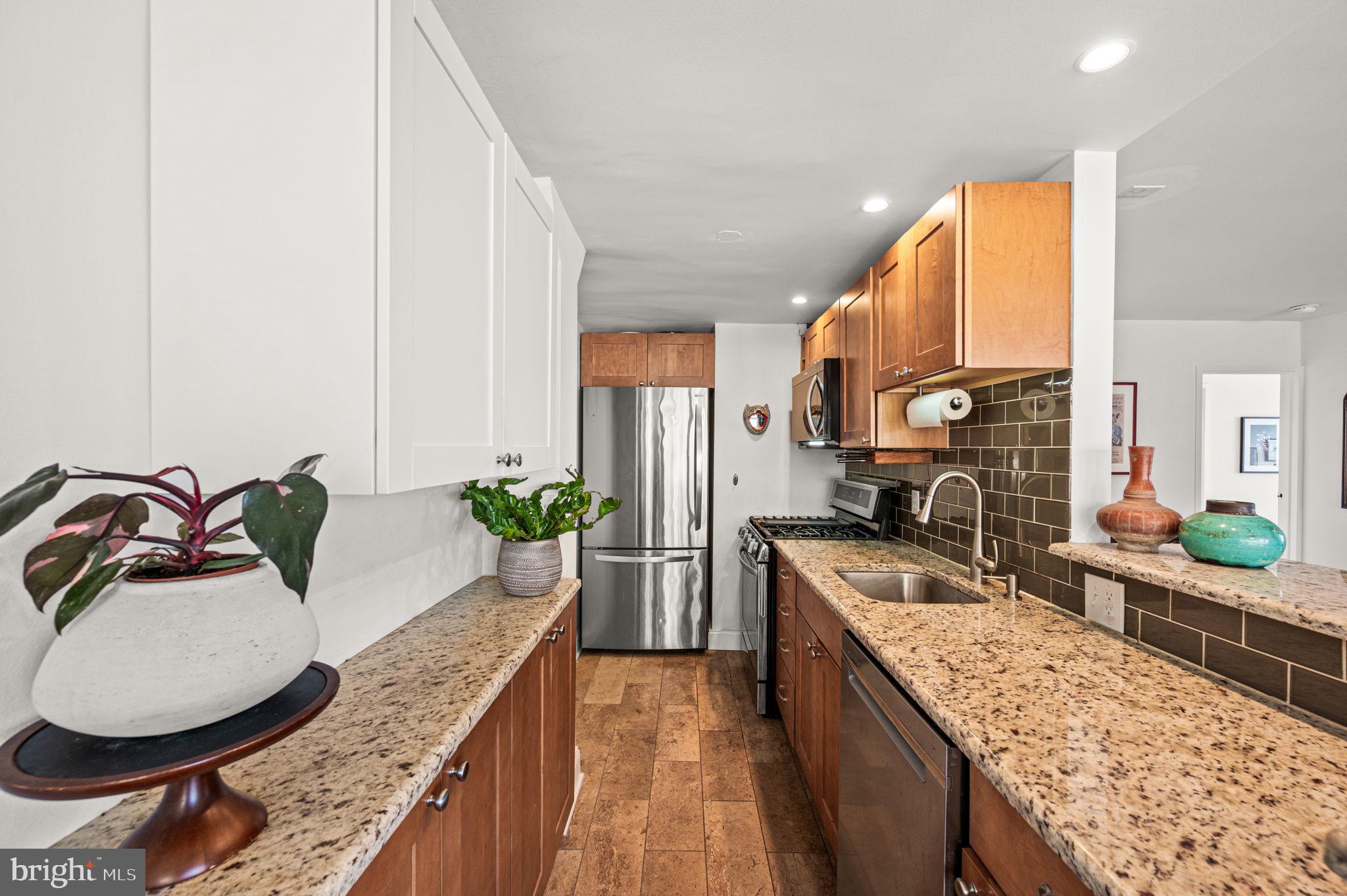 1806-18 Rittenhouse Square, Unit 190607 Philadelphia, PA 19103 - Photo 7 of 34 a kitchen with stainless steel appliances granite countertop a sink stove and cabinets