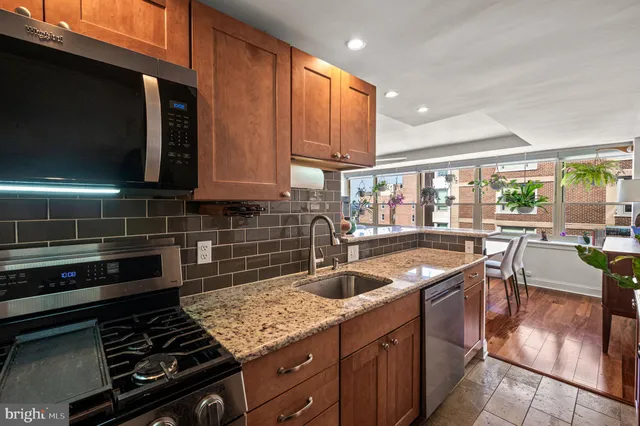 a kitchen with stainless steel appliances granite countertop a stove and a sink