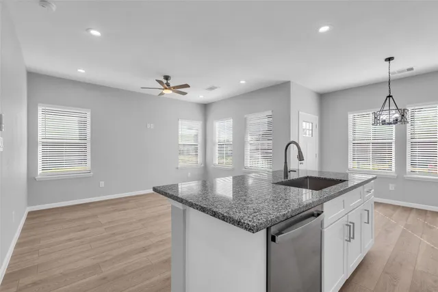 a kitchen with granite countertop a sink and center island