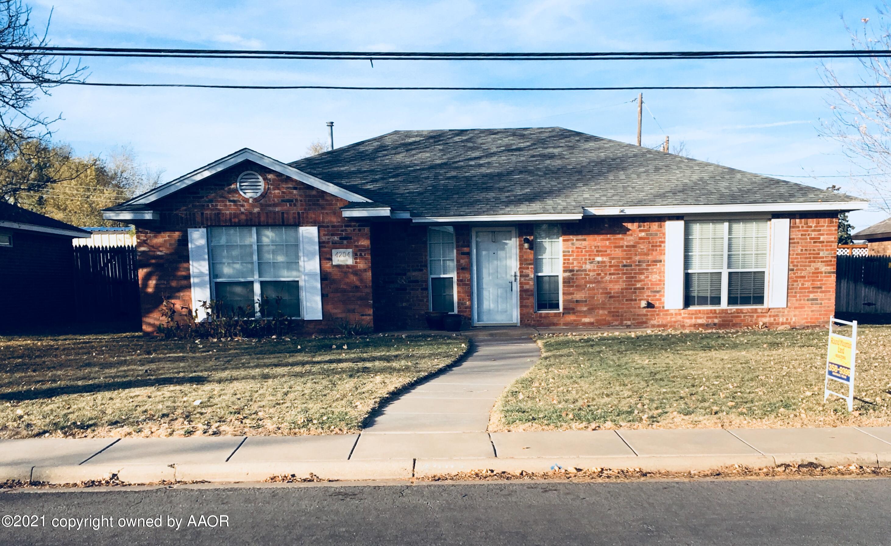 4204 Alamo Road Amarillo, TX 79110 - Photo 1 of 1 a view of a house with a small yard and plants
