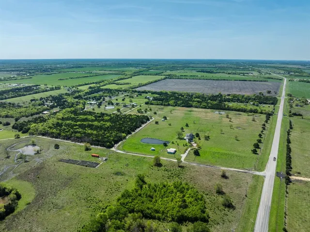 a view of a field with an ocean