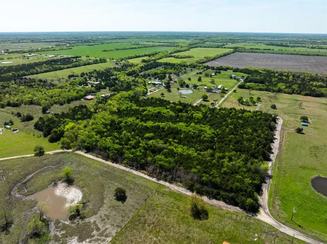 a view of a field with an ocean