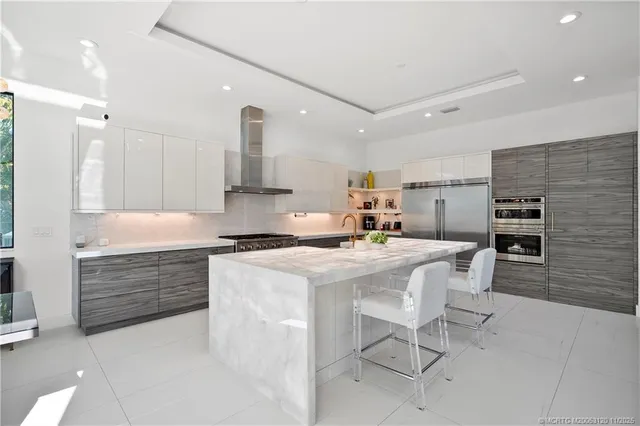 a dining room with furniture a chandelier and glass door